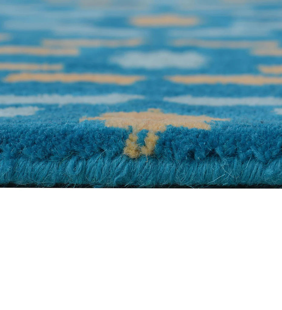Vibrant teal wool rug with playful yellow and white details