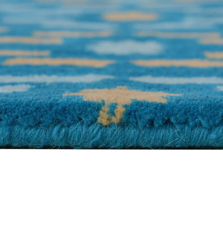 Vibrant teal wool rug with playful yellow and white details