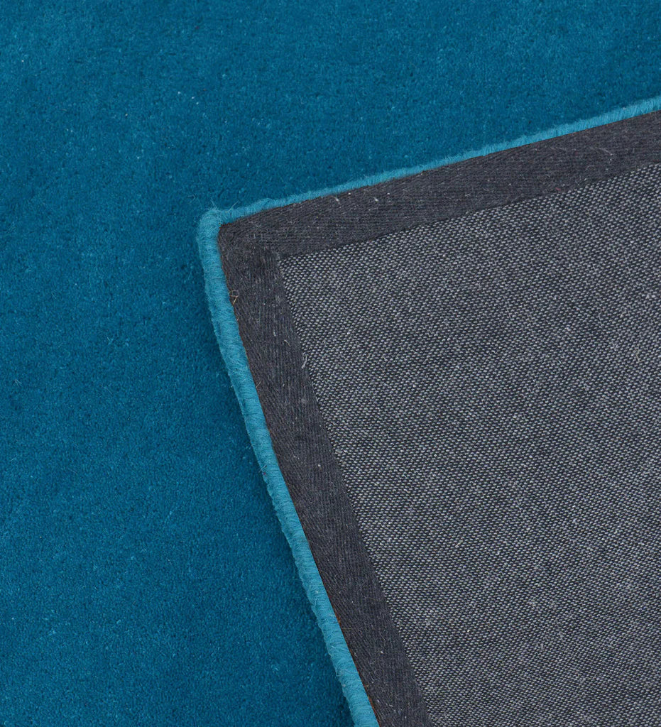 Premium hand-tufted wool rug in solid teal blue