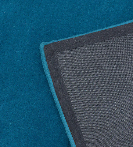 Premium hand-tufted wool rug in solid teal blue