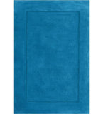 Solid teal hand-tufted wool rug with minimalist border design