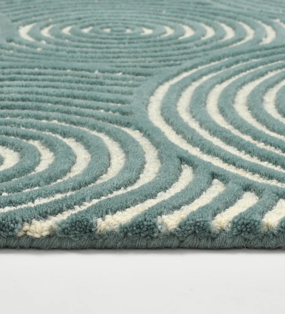 Contemporary teal rug with ivory concentric line pattern