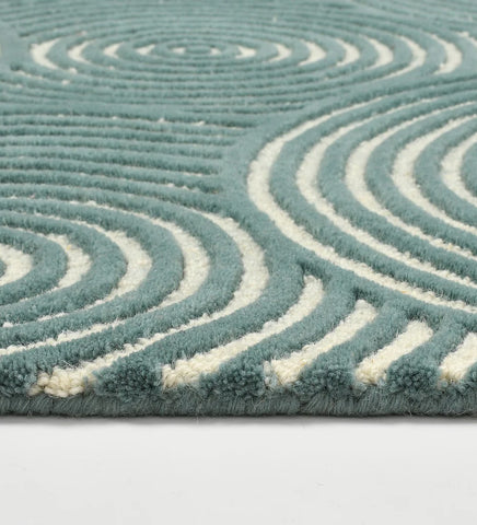 Contemporary teal rug with ivory concentric line pattern