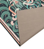 Luxury handwoven rug with teal and peach abstract floral design, folded corner showing beige backing