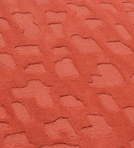 Luxury terracotta wool rug with raised abstract details