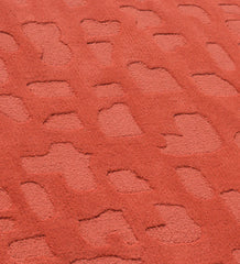 Luxury terracotta wool rug with raised abstract details