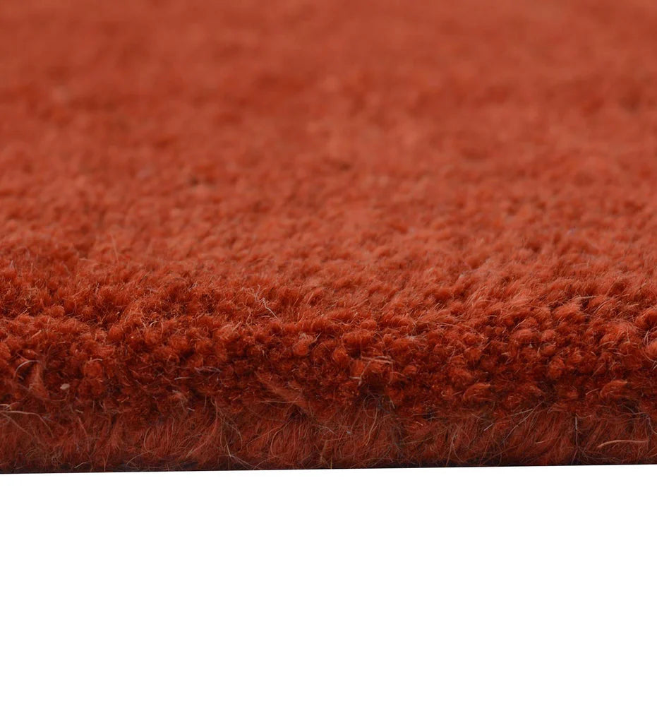 Premium hand-tufted rug in terracotta with embossed detailing