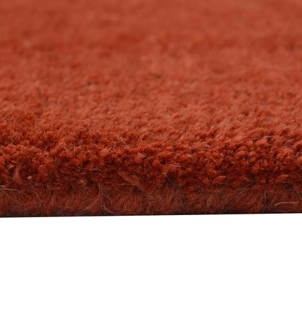 Premium hand-tufted rug in terracotta with embossed detailing