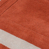 Luxury hand-tufted wool rug in terracotta and beige minimalist design