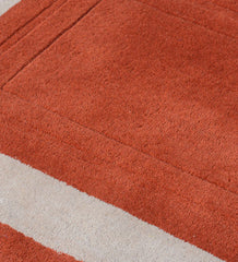 Luxury hand-tufted wool rug in terracotta and beige minimalist design