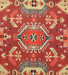 Low-profile terracotta rug with cream and gold accents.