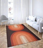 Modern living room with terracotta retro geometric arch rug on wooden floor, gray sofa, and black white striped chair