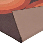 Terracotta retro geometric arch rug with warm orange, brown, and rust tones, showing textured weave and edge detail
