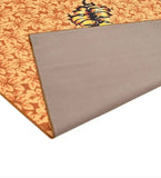 Luxury handwoven floral rug with tiger print on orange and yellow background, folded corner showing gray back