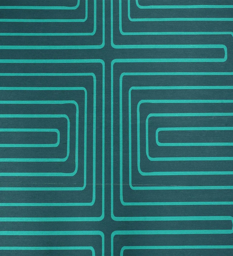 Low-profile turquoise rug with white maze design.