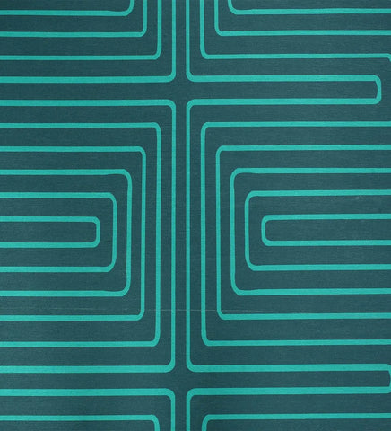 Low-profile turquoise rug with white maze design.