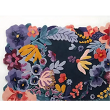 Luxury handwoven floral rug with colorful purple, pink, yellow, and green blossoms on dark background