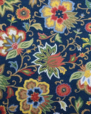 Luxury handwoven rug with colorful floral patterns on deep blue background from Mannat Rugs