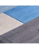 Close-up of luxury modern rug with geometric pattern in blue, gray, and beige colors