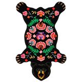 Black bear-shaped rug with colorful floral embroidery and green leaf patterns from Mannat Rugs