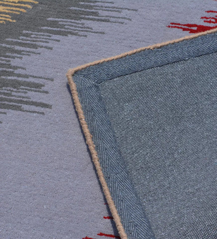 Hand-tufted rug with dynamic red, blue, and beige strokes