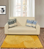 Cream sofa with patterned blue and green cushions on yellow wool rug with white geometric design in bright living room