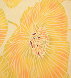 Close-up of a yellow modern floral rug with intricate handwoven design and orange accents