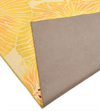 Yellow modern floral rug with leaf patterns, showing non-slip grey backing, luxury handwoven design