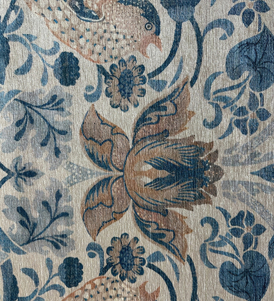 Close-up of a floral and bird pattern on fabric with blue and brown colors.
