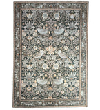 Decorative rug with floral and bird pattern on a white background