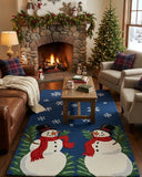 Living room with Christmas decorations, including a fireplace, tree, and snowman-themed rug.