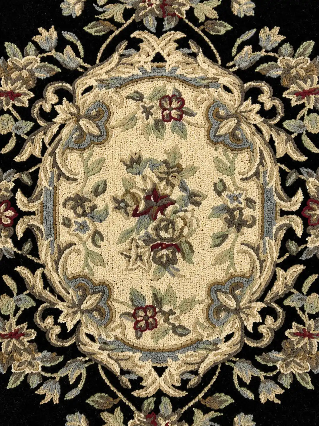 Close-up of an ornate rug with floral patterns on a black background