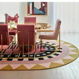 Luxury dining room with gold and pink chairs around a round gold table on a colorful geometric area rug
