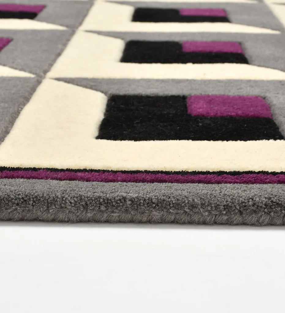 Geometric patterned rug with purple, black, and white squares on a gray background