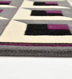 Geometric patterned rug with purple, black, and white squares on a gray background