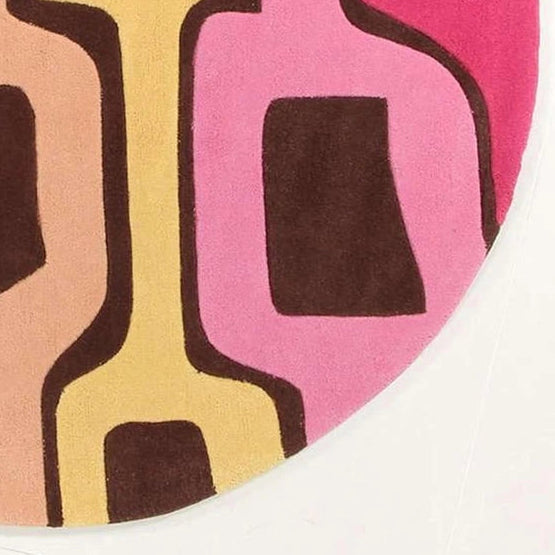 Close-up of blue pink and yellow geometric pattern on colorful wool rug for a bedroom, 6ft round size