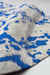 Abstract wool rug with beige and blue contemporary pixel-inspired motifs.