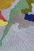 Featuring an abstract color-block pattern round hand tufted rug in muted tones of blue, grey, mustard yellow, olive green, blush red, and soft pastels.
