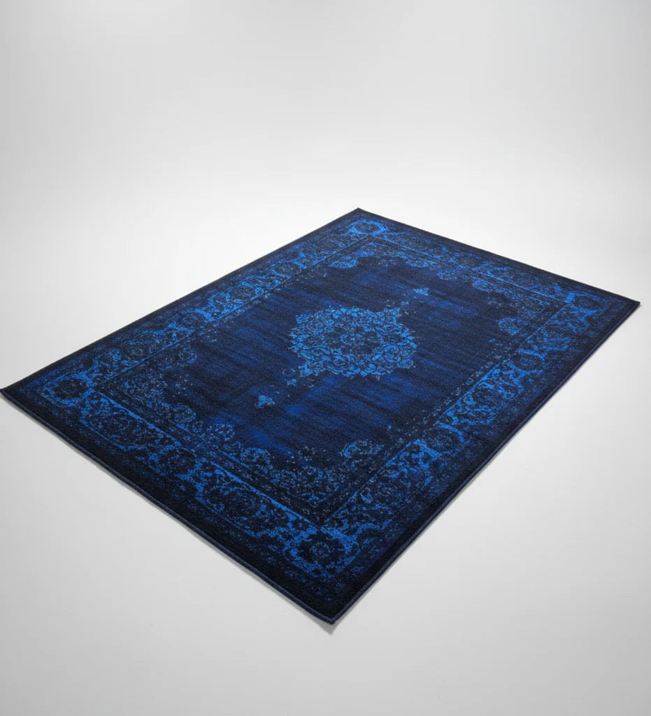 Blue patterned rug on a light gray background