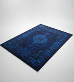 Blue patterned rug on a light gray background