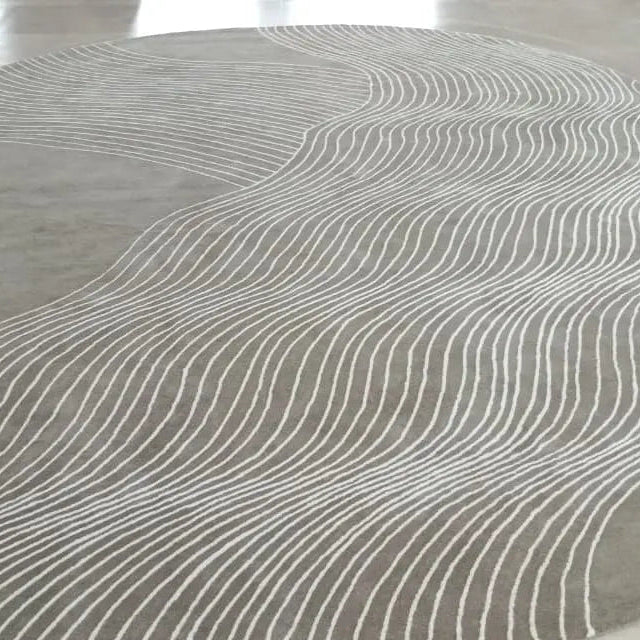 Round gray rug with wavy pattern on a light-colored floor